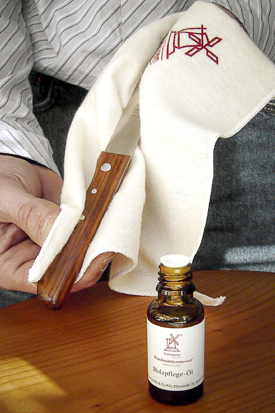 Oiling the wooden handles with wood care oil